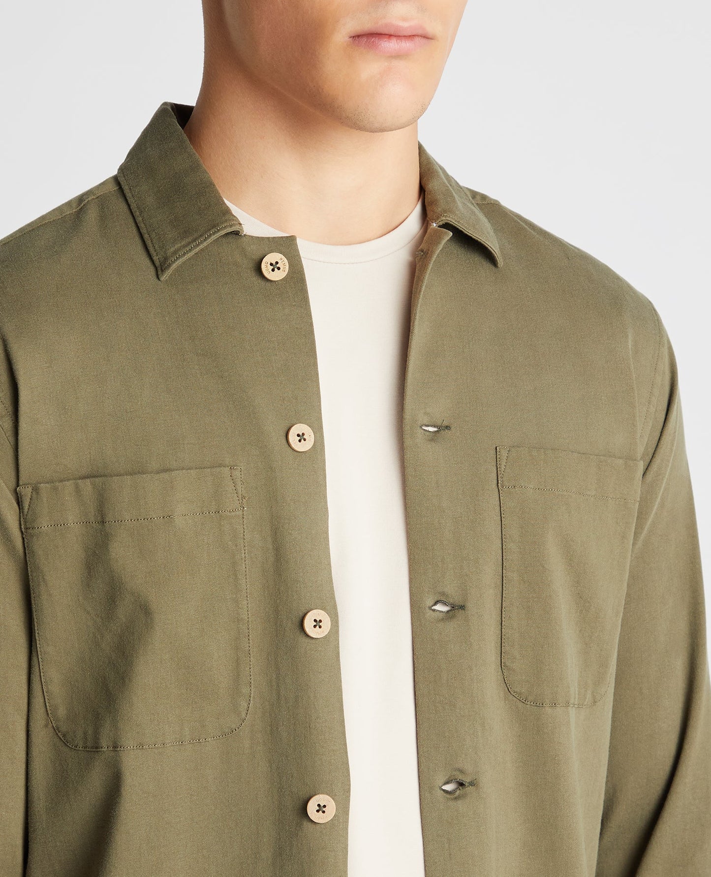 Man wearing a green Tapered Fit Long Sleeve Tencel Overshirt