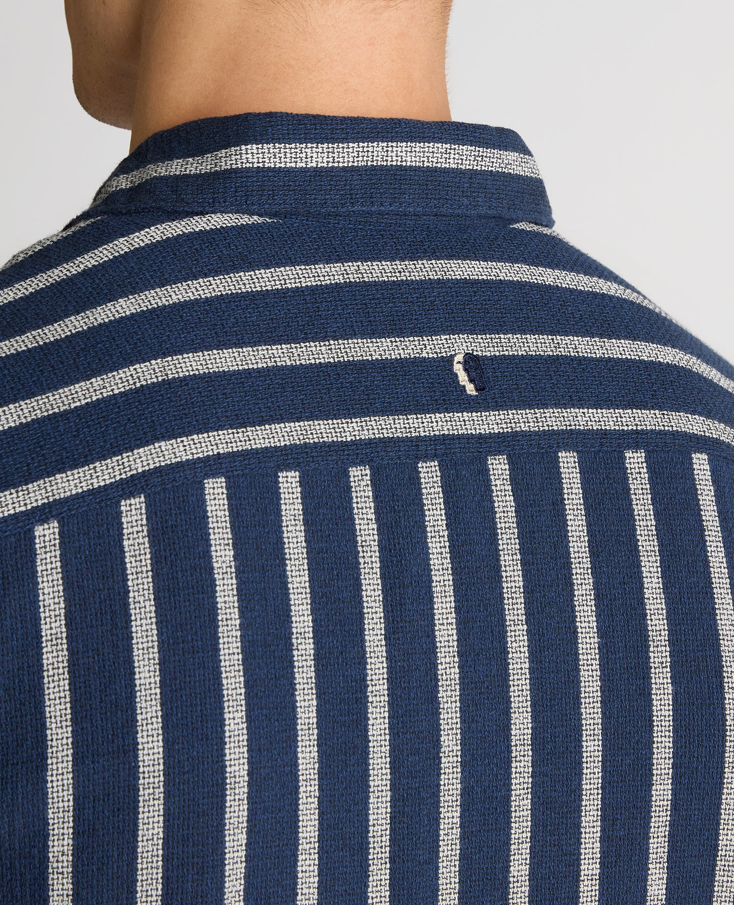 Man wearing a navy Tapered Fit Striped Cotton-Blend Shirt