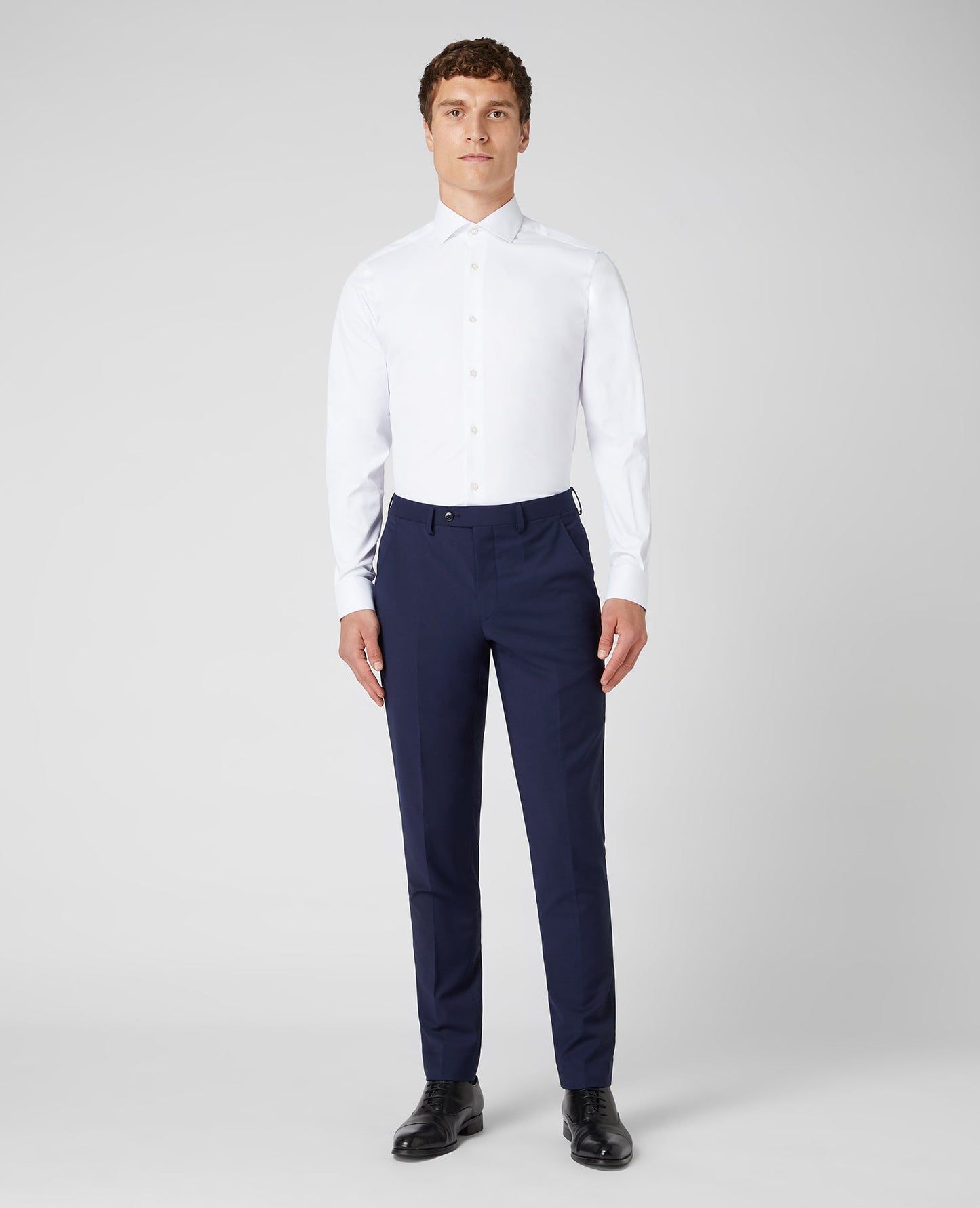 Man wearing a white Tapered Fit Cotton Stretch Shirt