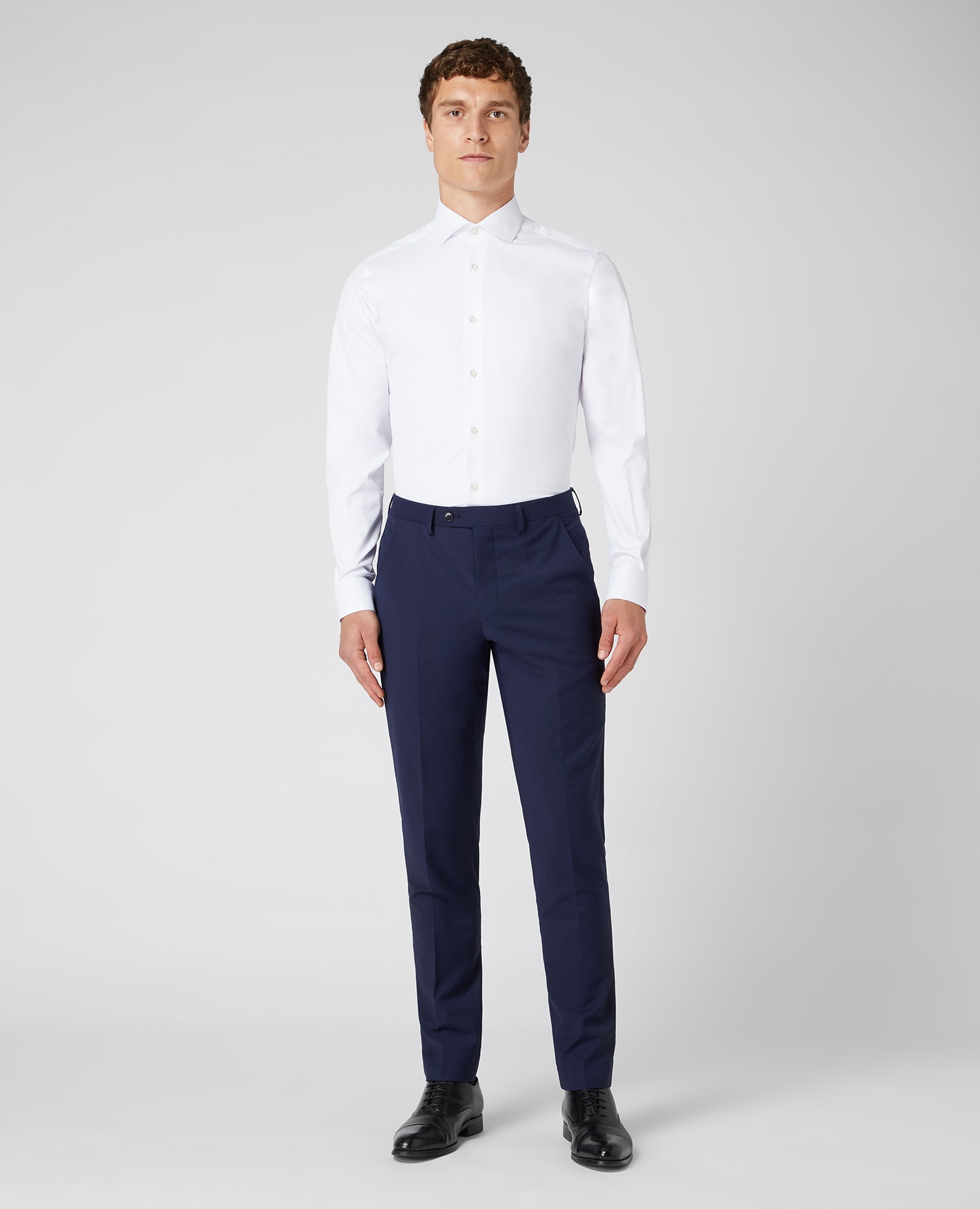 Man wearing a white Tapered Fit Cotton Stretch Shirt