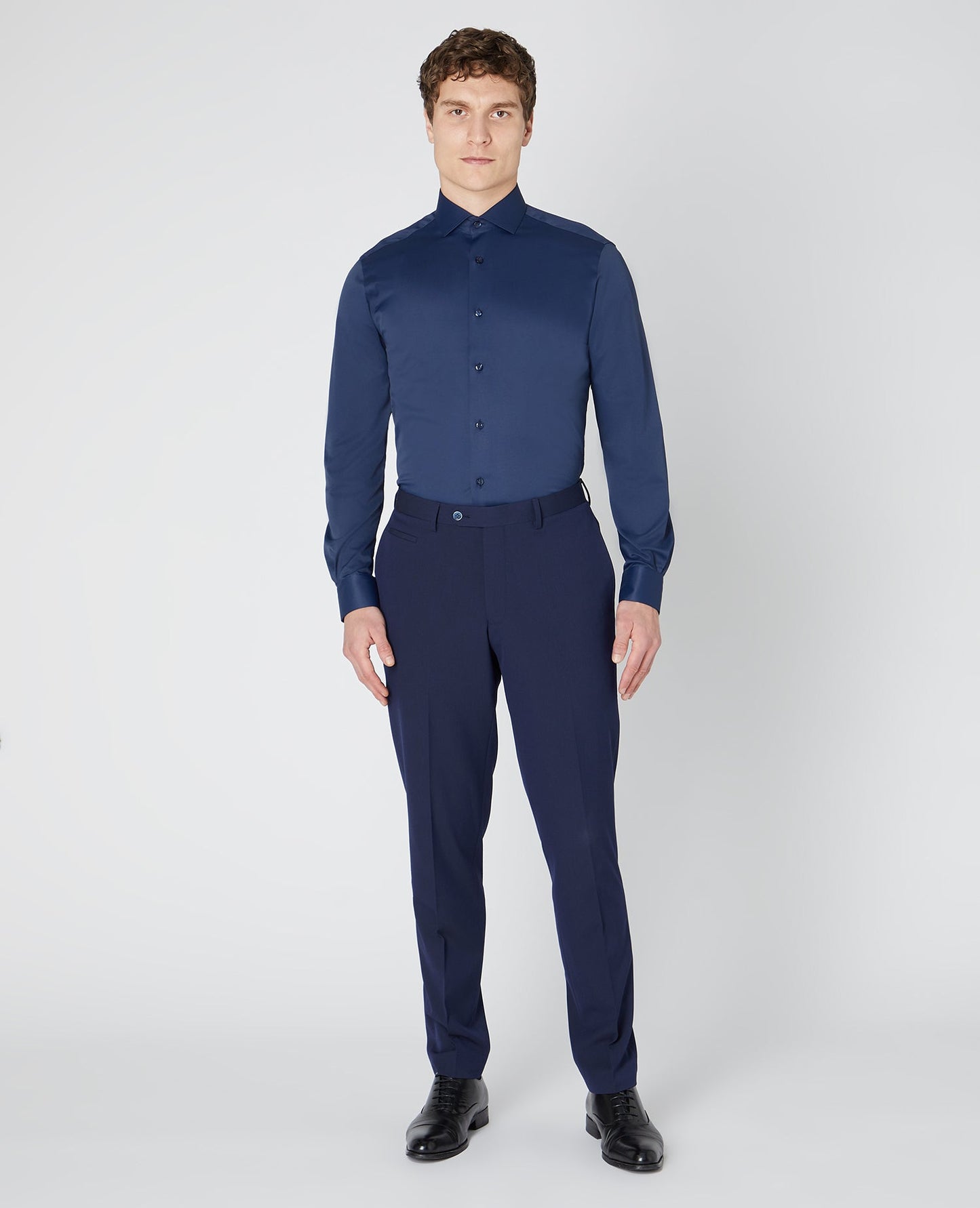 Man wearing a navy Tapered Fit Cotton Stretch Shirt