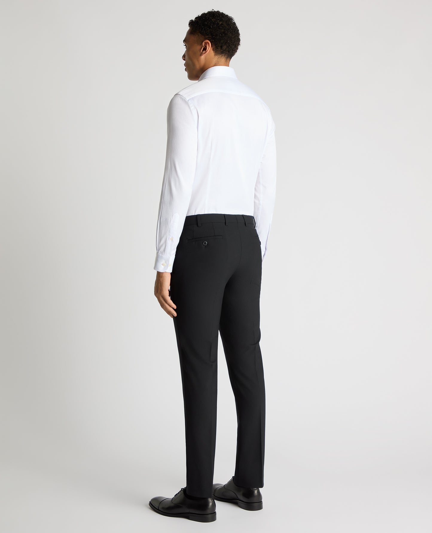 Man wearing a white Slim Fit Cotton Stretch Jacquard Shirt