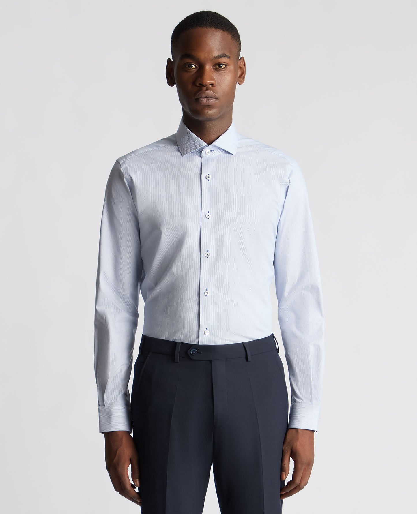 Man wearing a blue Tapered Fit Cotton Stretch Pinstripe Shirt