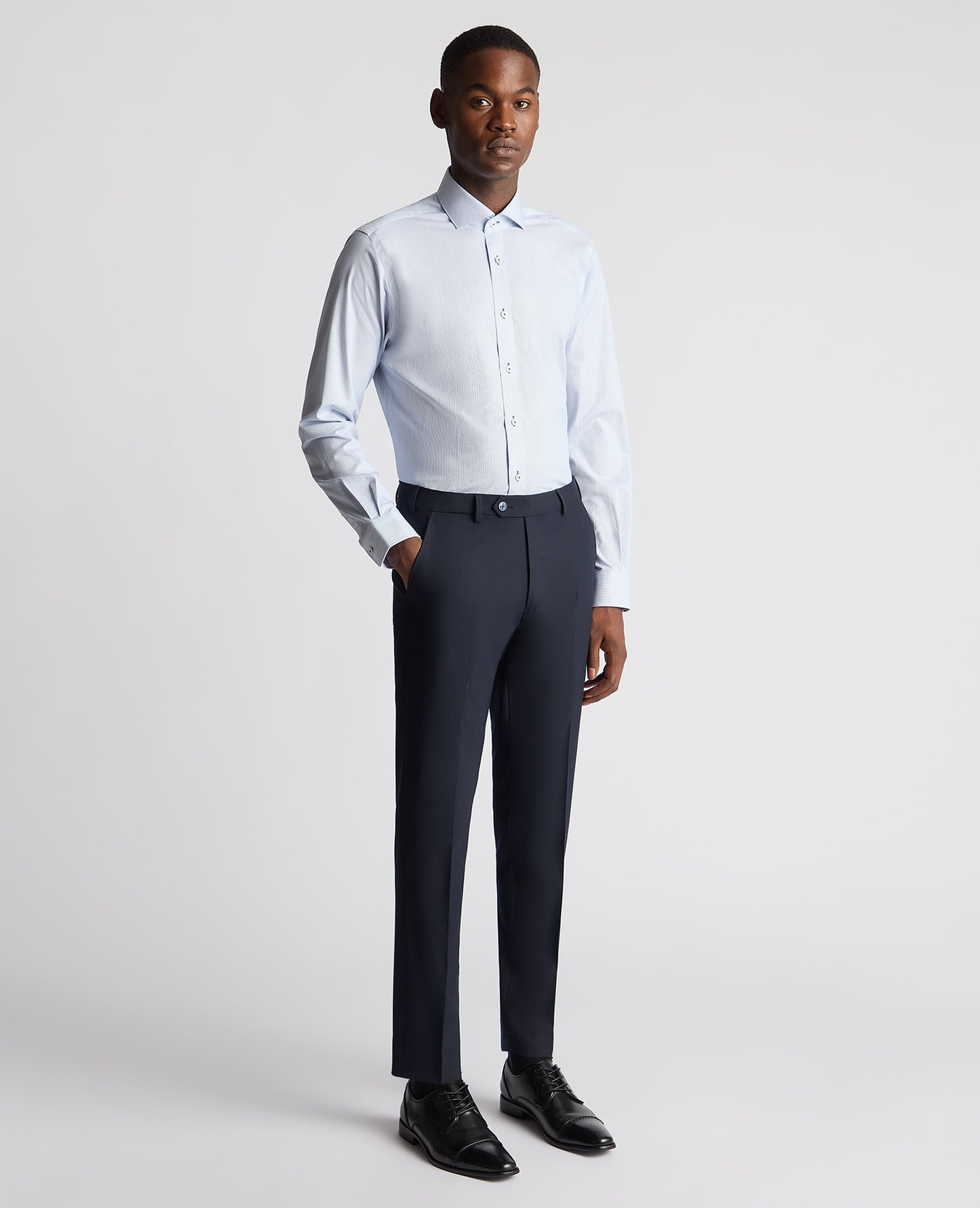 Man wearing a blue Tapered Fit Cotton Stretch Pinstripe Shirt