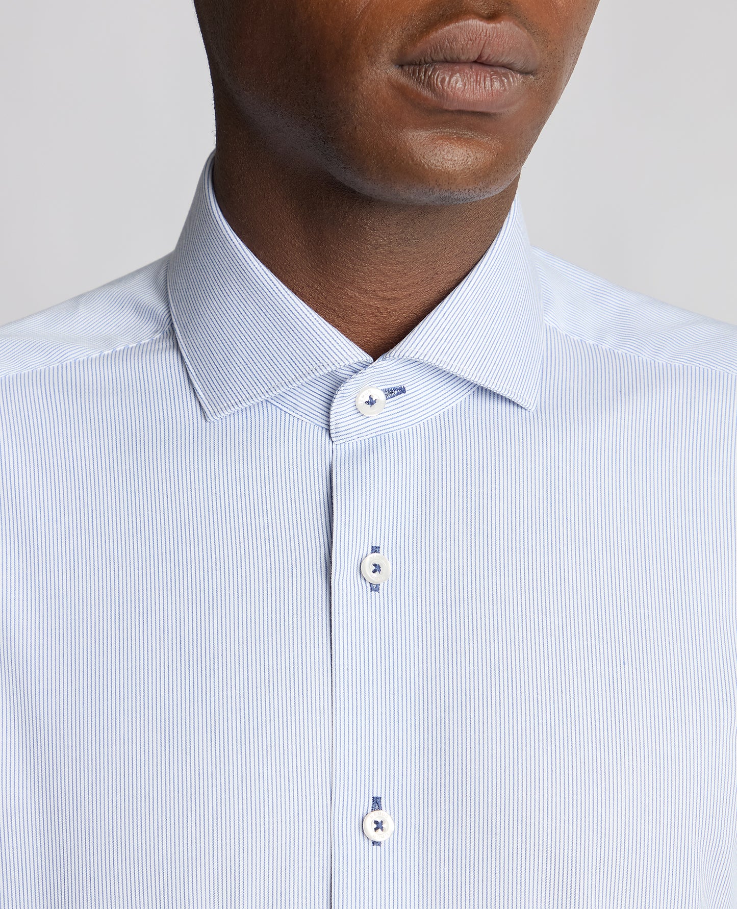 Man wearing a blue Tapered Fit Cotton Stretch Pinstripe Shirt