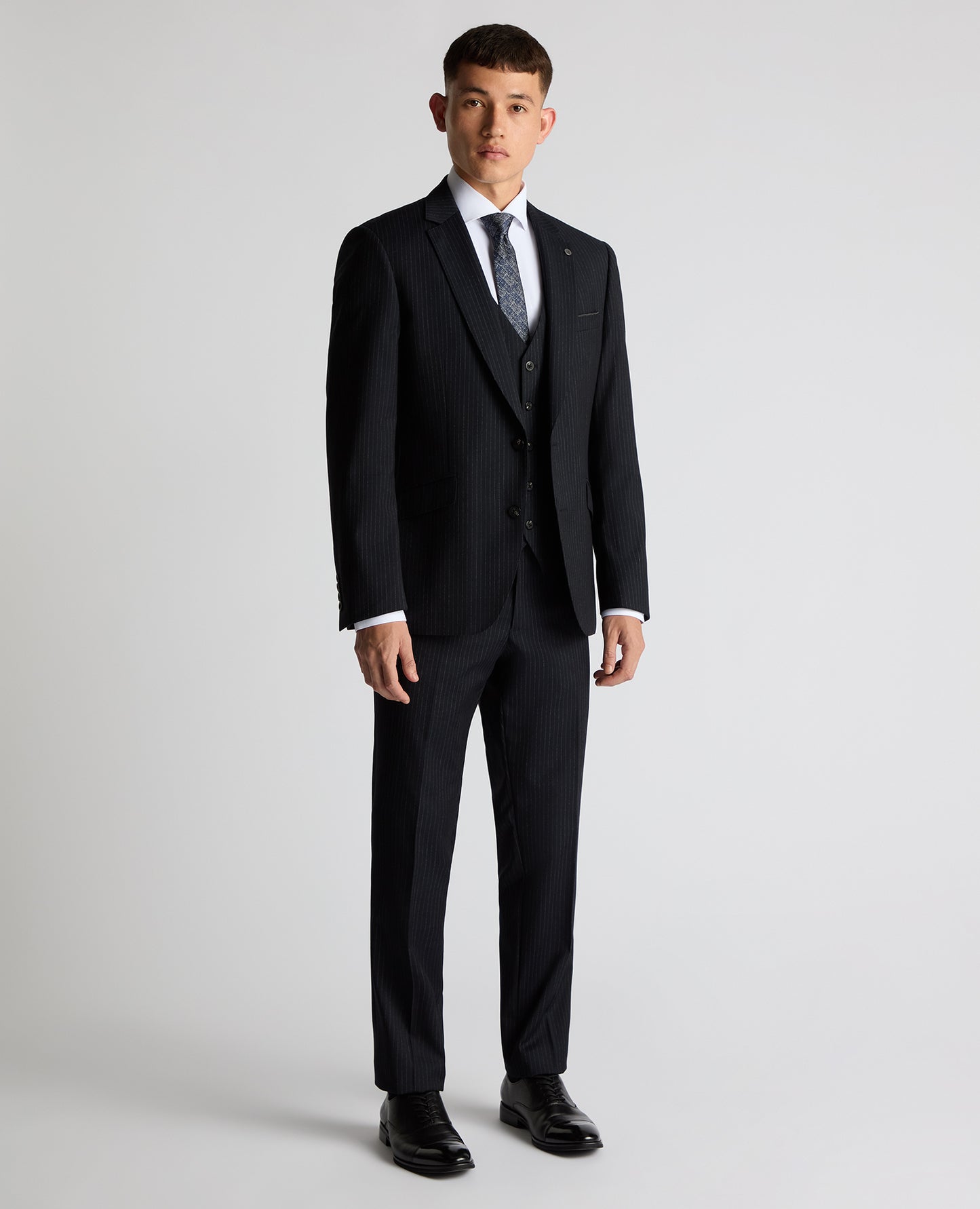 Man wearing a navy Tapered Fit Wool Rich Suit