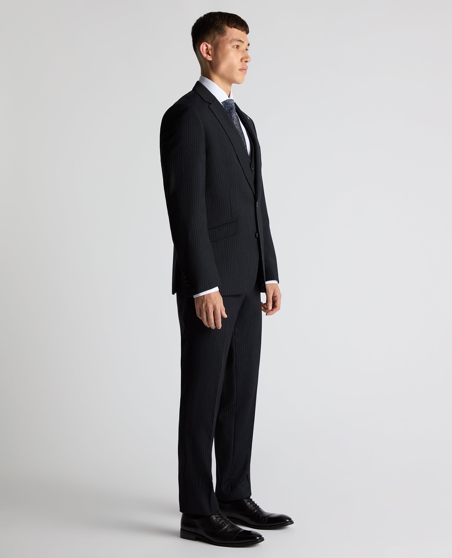 Man wearing a navy Tapered Fit Wool Rich Suit