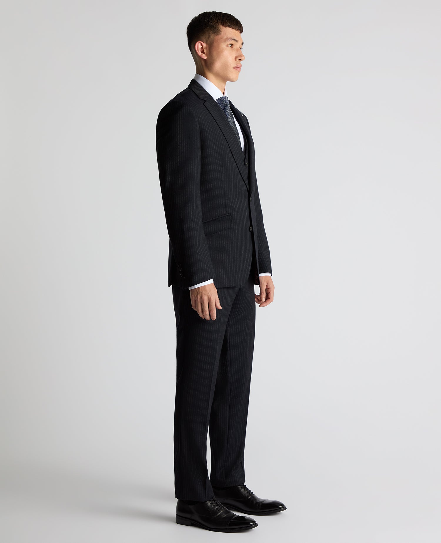 Man wearing a navy Tapered Fit Wool Rich Suit