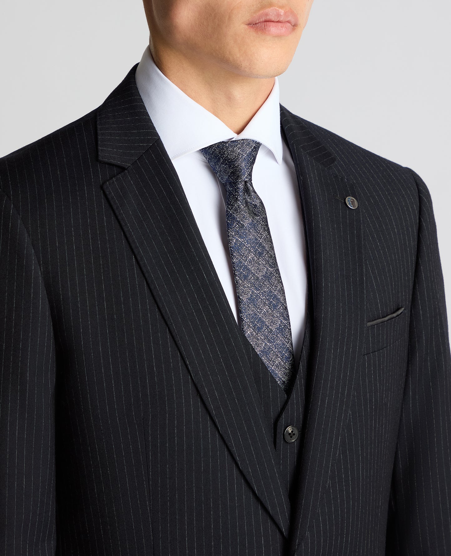 Man wearing a navy Tapered Fit Wool Rich Suit