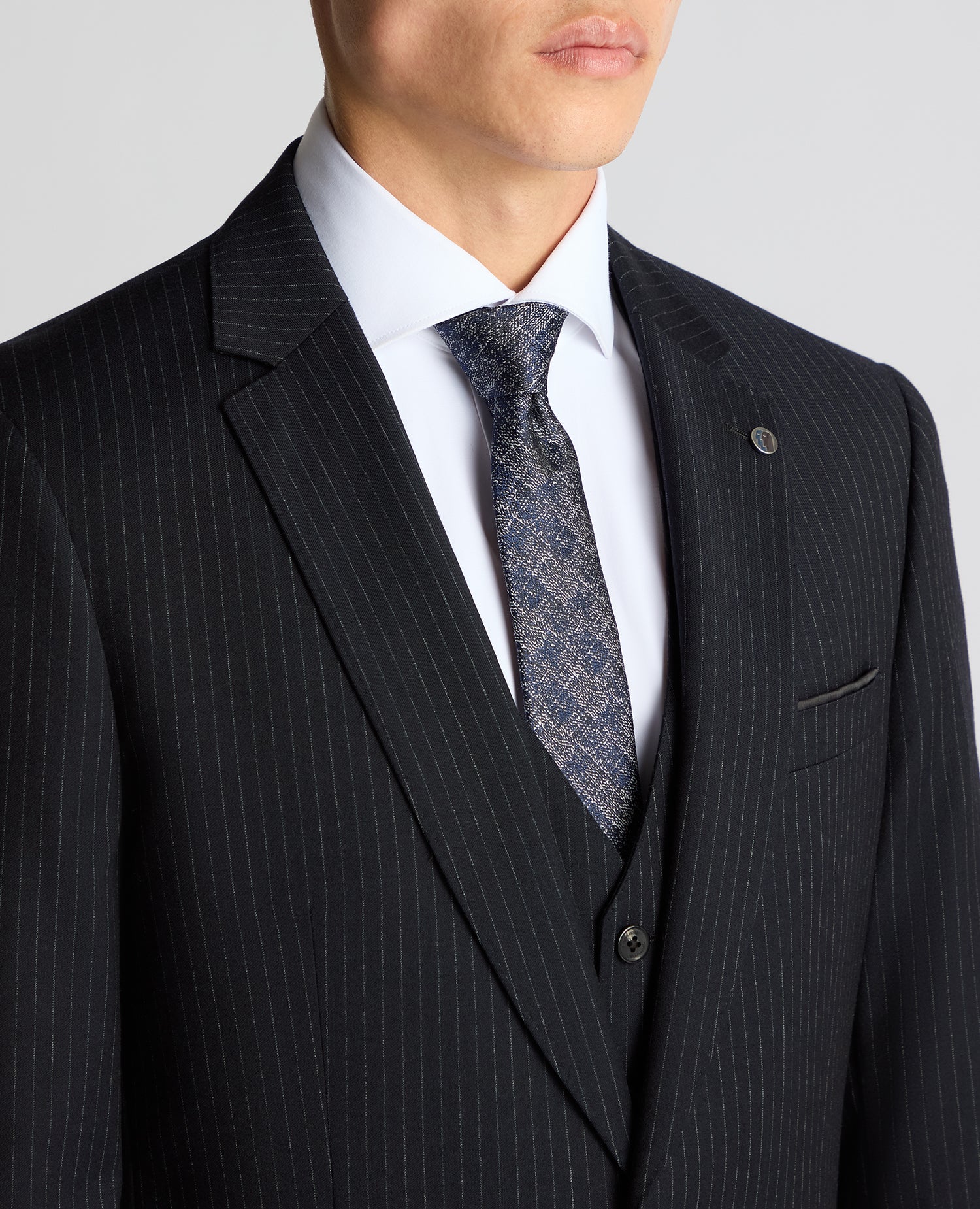 Man wearing a navy Tapered Fit Wool Rich Suit