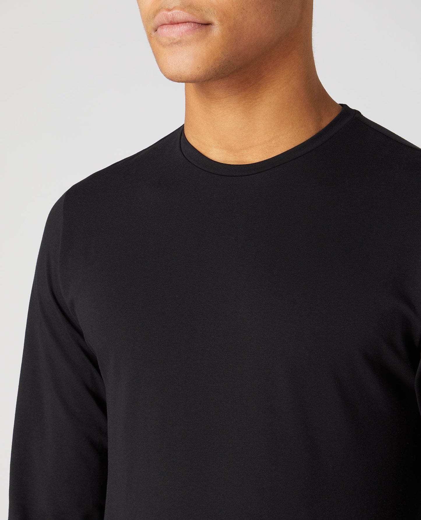 Man wearing a black Tapered Fit Cotton-Stretch Long Sleeve T-Shirt