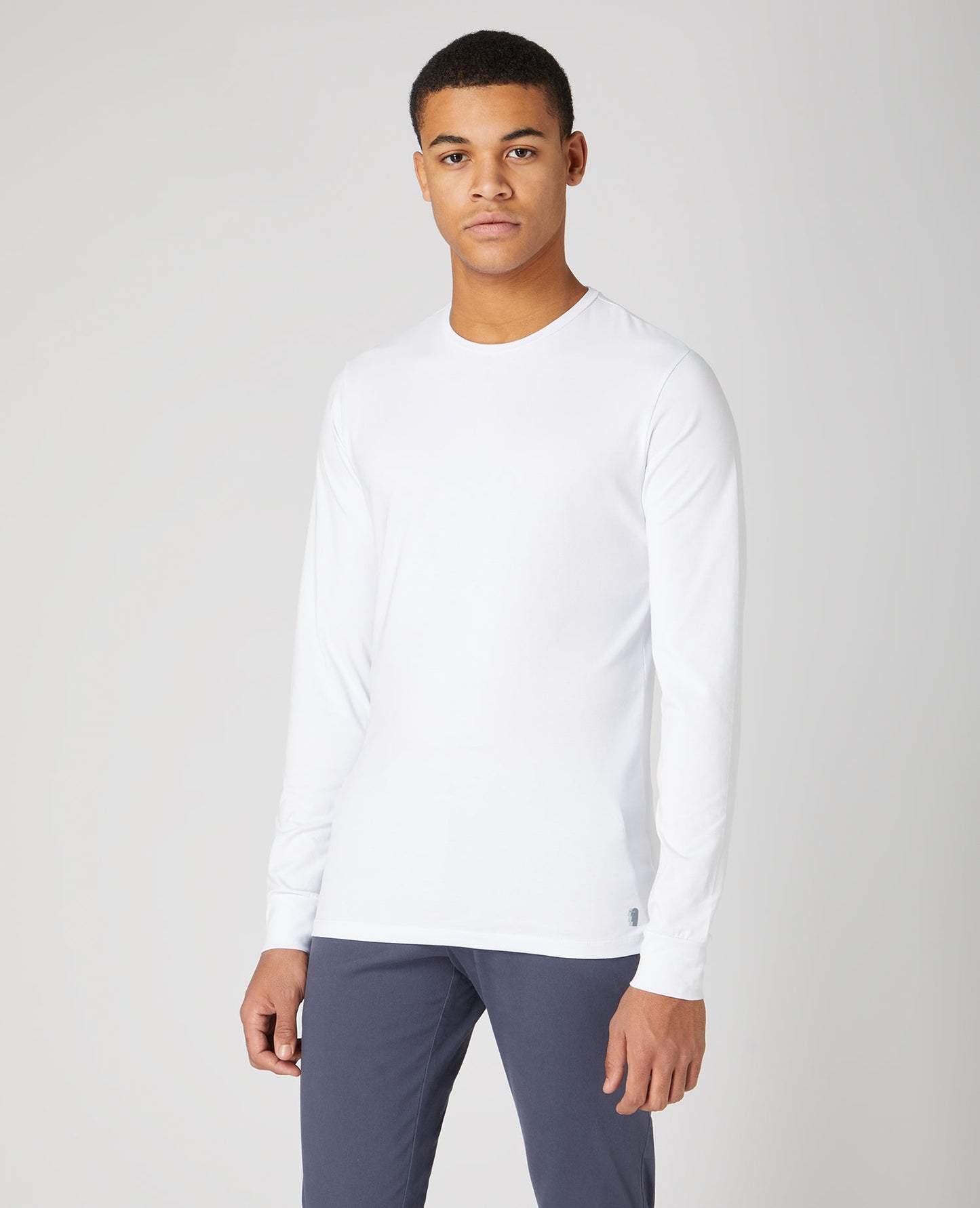 Man wearing a white Tapered Fit Cotton-Stretch Long Sleeve T-Shirt