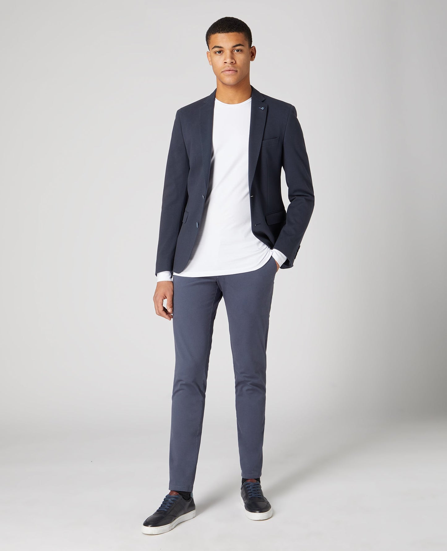 Man wearing a white Tapered Fit Cotton-Stretch Long Sleeve T-Shirt