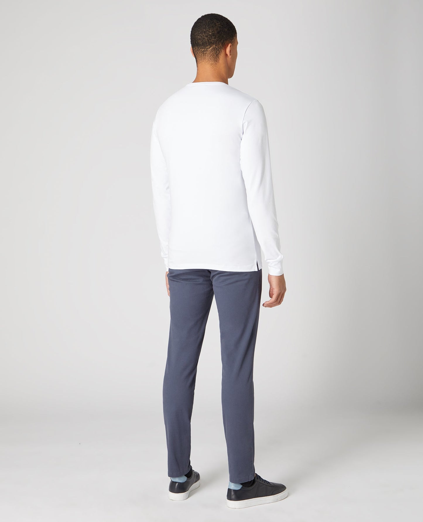 Man wearing a white Tapered Fit Cotton-Stretch Long Sleeve T-Shirt