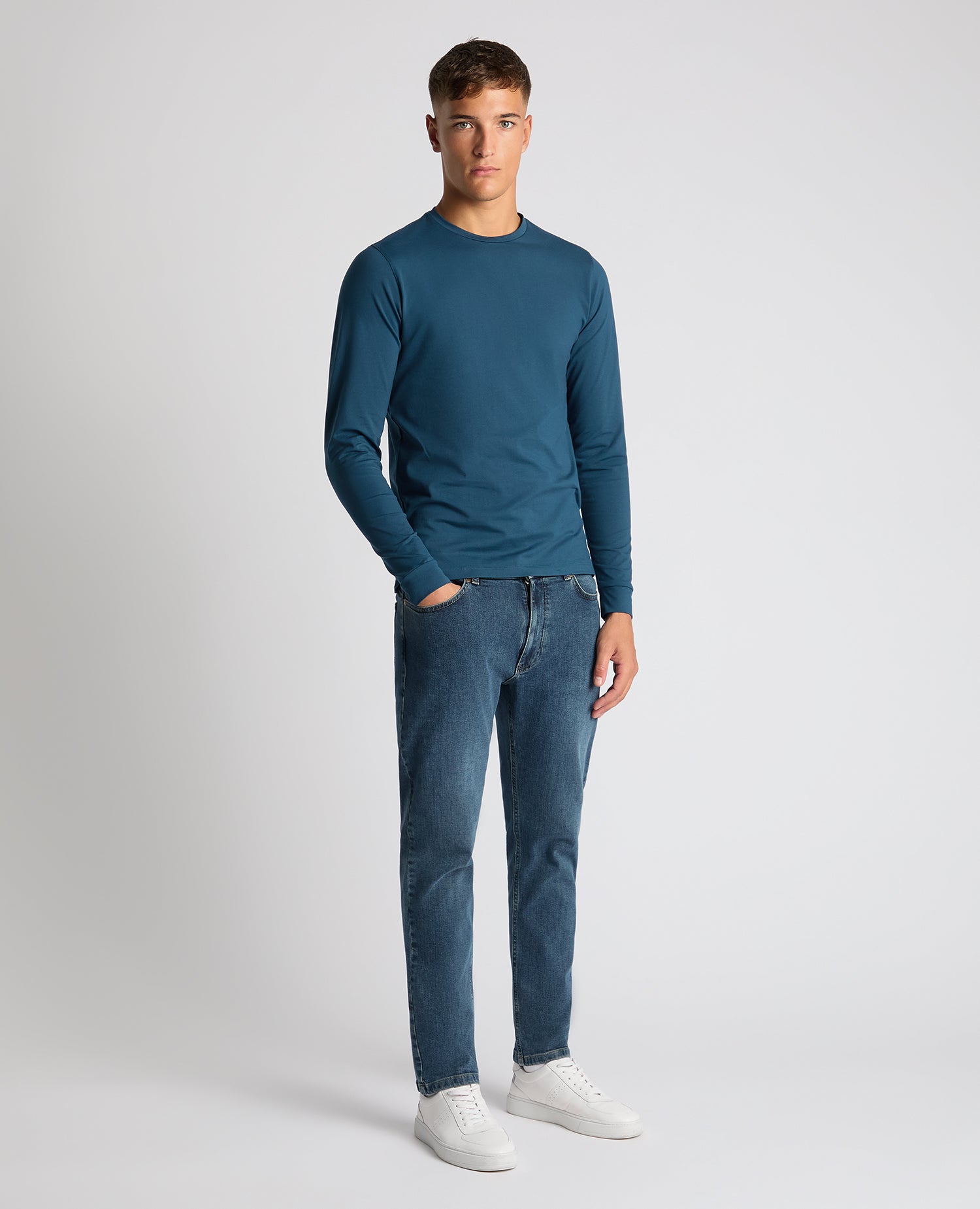 Man wearing a blue Tapered Fit Cotton-Stretch T-Shirt