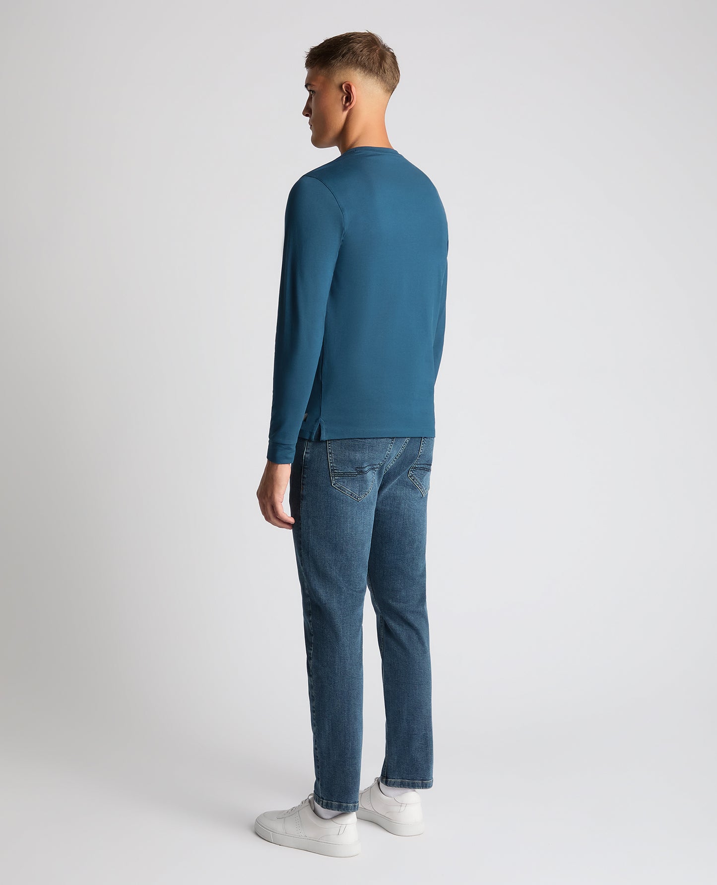Man wearing a blue Tapered Fit Cotton-Stretch T-Shirt