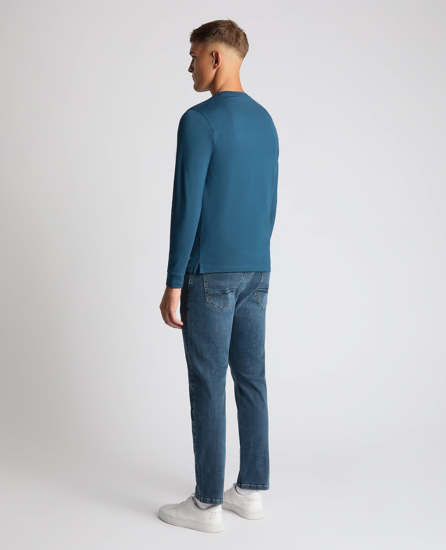 Man wearing a blue Tapered Fit Cotton-Stretch T-Shirt