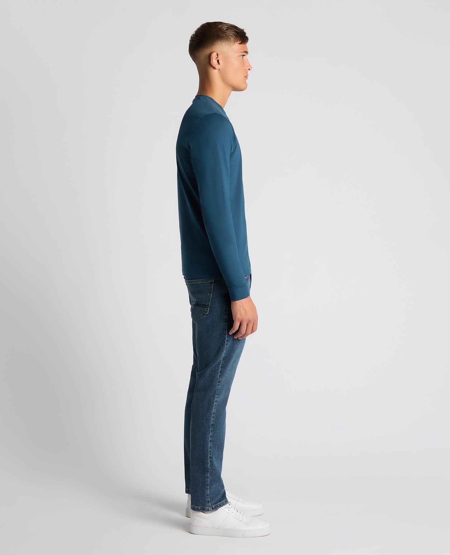 Man wearing a blue Tapered Fit Cotton-Stretch T-Shirt