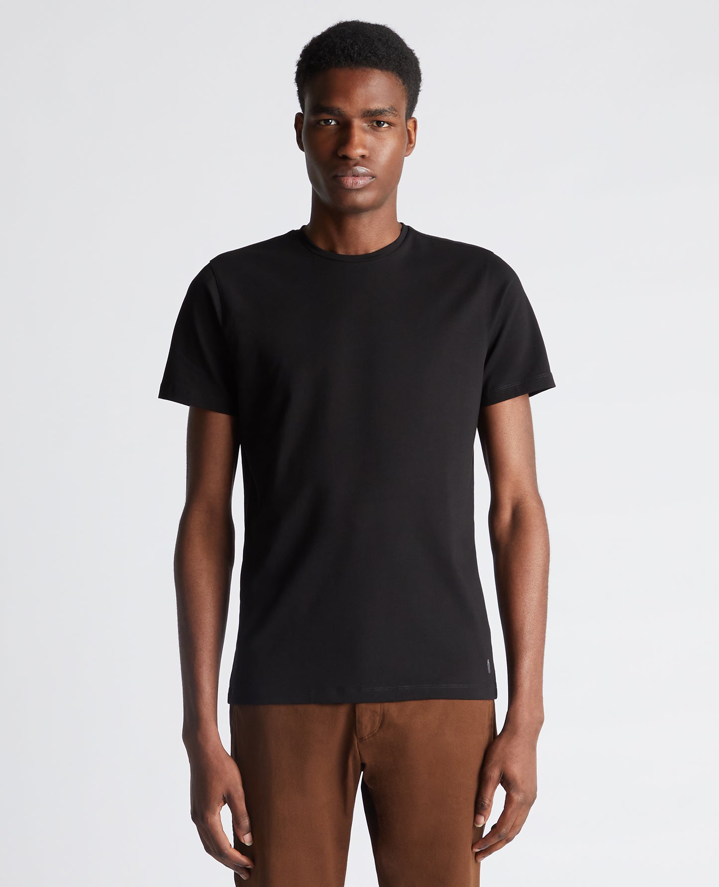 Man wearing a black Tapered Fit Cotton-Stretch T-Shirt