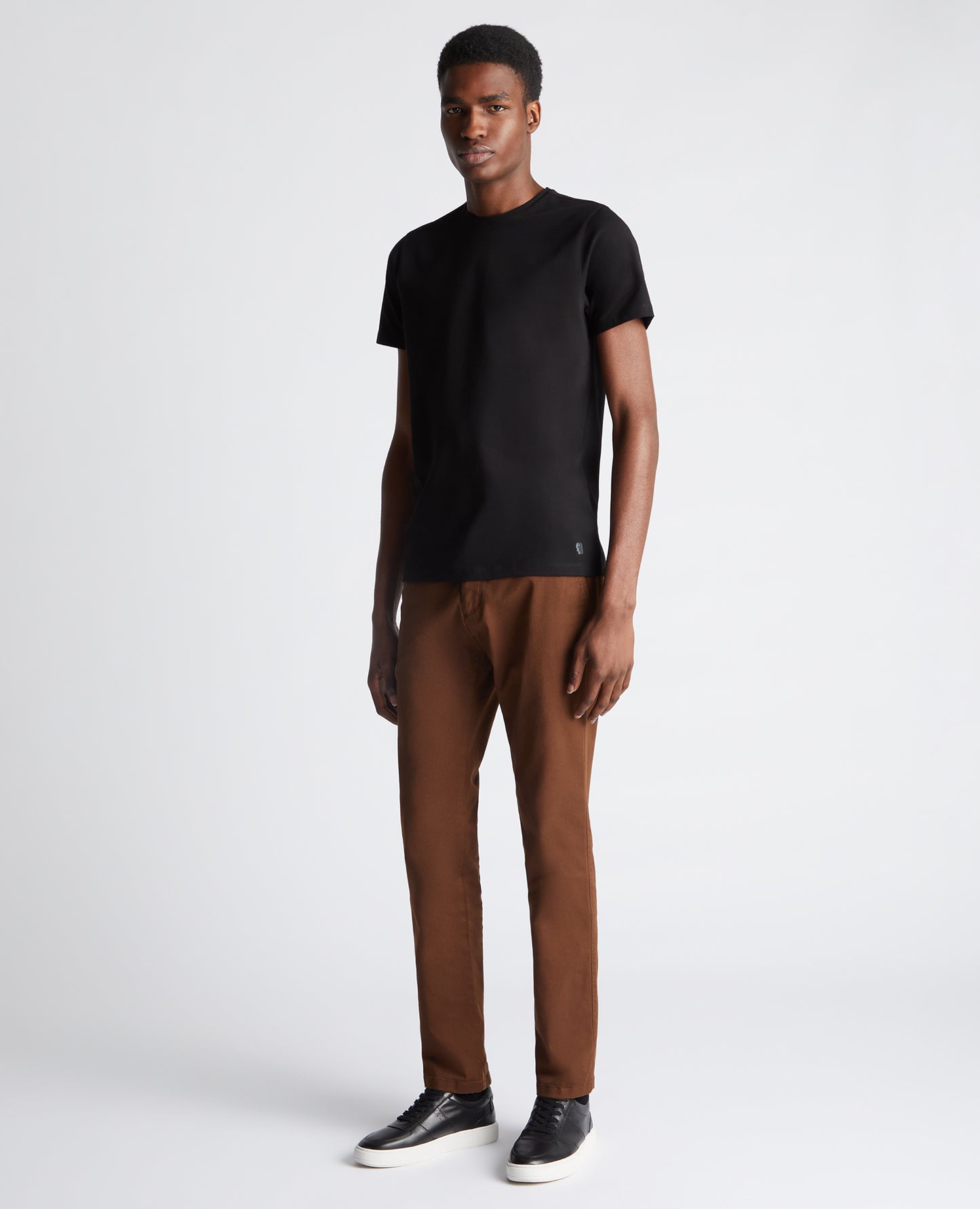 Man wearing a black Tapered Fit Cotton-Stretch T-Shirt