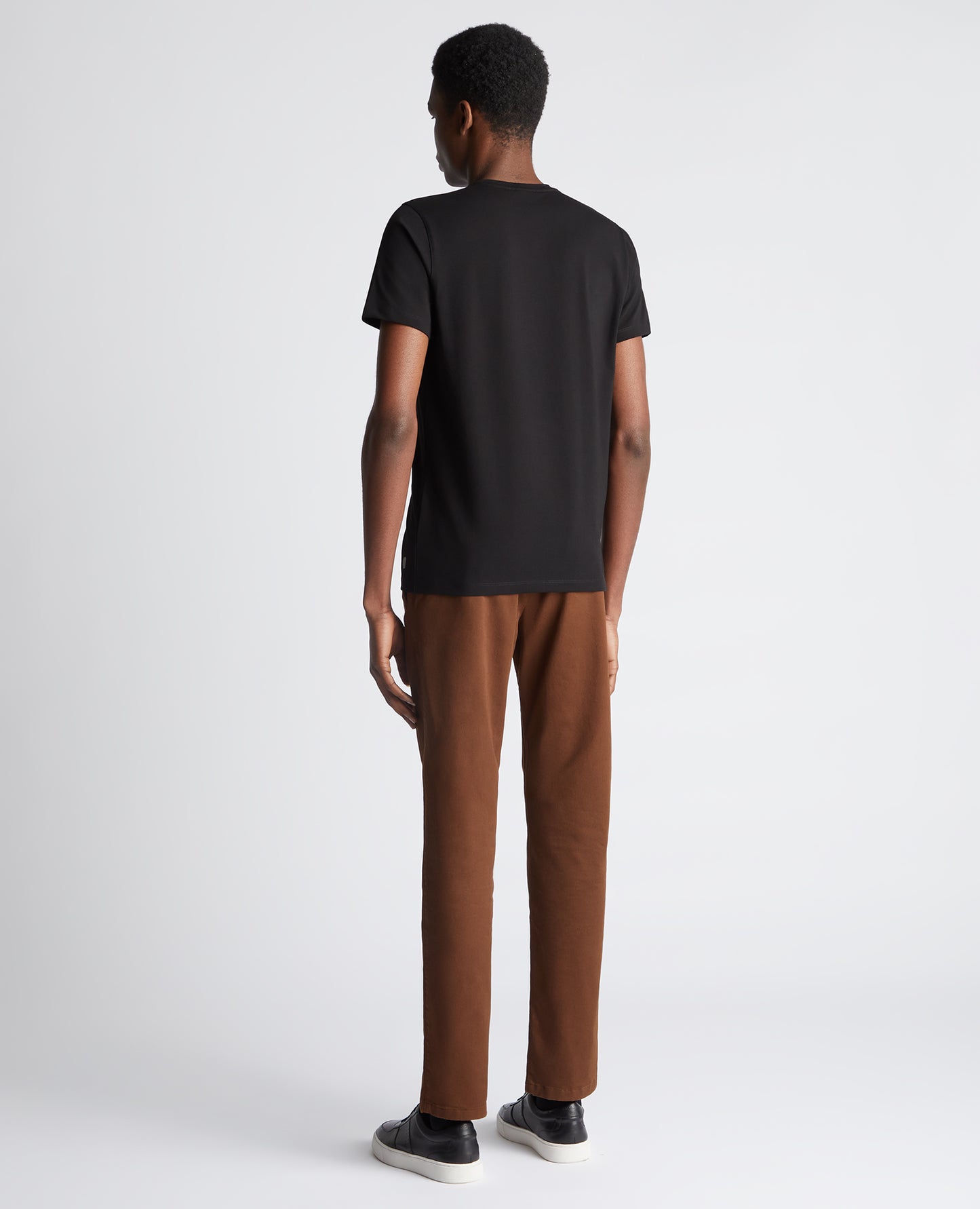 Man wearing a black Tapered Fit Cotton-Stretch T-Shirt