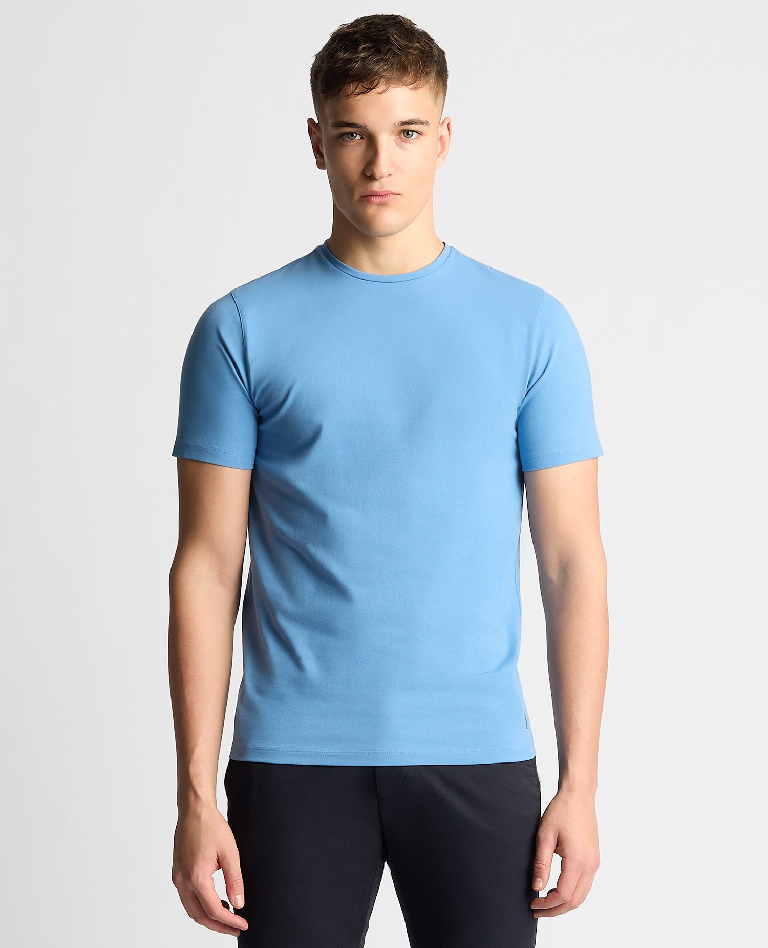 Man wearing a blue Tapered Fit Cotton-Stretch T-Shirt