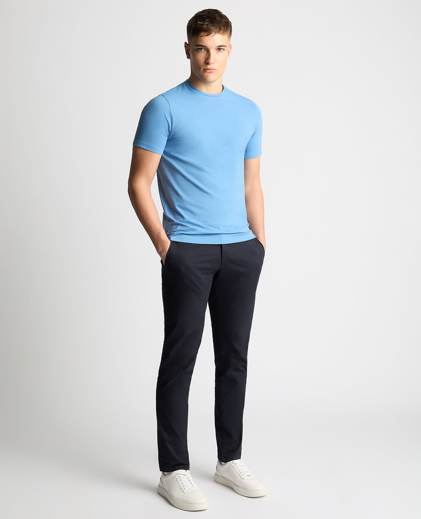 Man wearing a blue Tapered Fit Cotton-Stretch T-Shirt