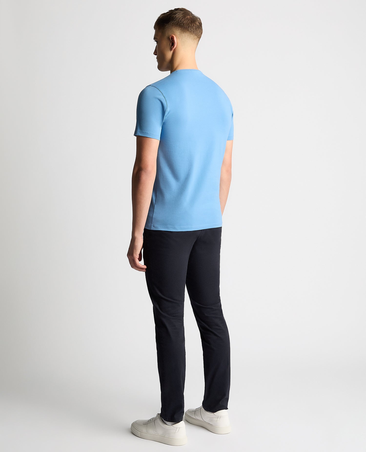 Man wearing a blue Tapered Fit Cotton-Stretch T-Shirt