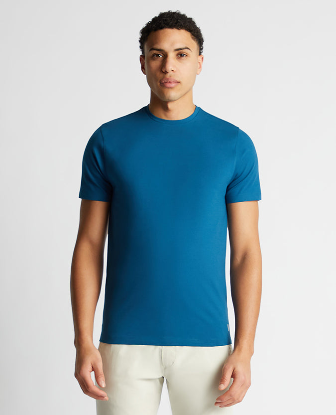 Man wearing a blue Tapered Fit Cotton-Stretch T-Shirt