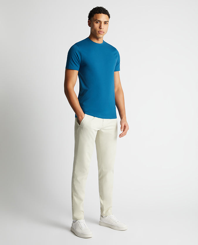 Man wearing a blue Tapered Fit Cotton-Stretch T-Shirt