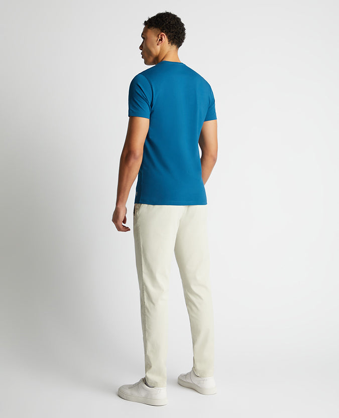Man wearing a blue Tapered Fit Cotton-Stretch T-Shirt