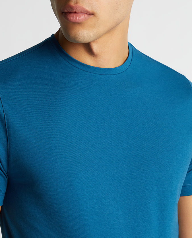 Man wearing a blue Tapered Fit Cotton-Stretch T-Shirt