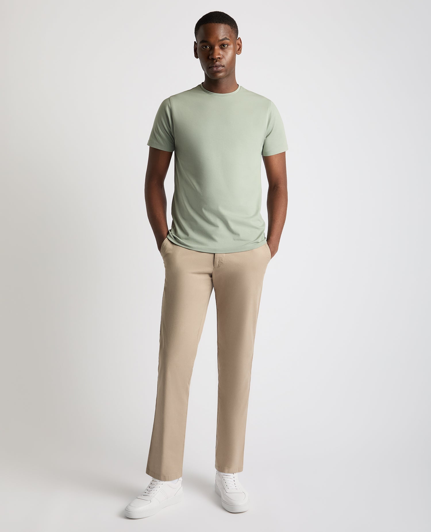 Man wearing a green Tapered Fit Cotton-Stretch T-Shirt