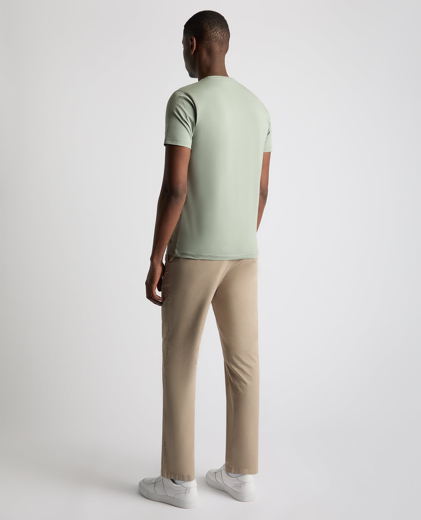 Man wearing a green Tapered Fit Cotton-Stretch T-Shirt