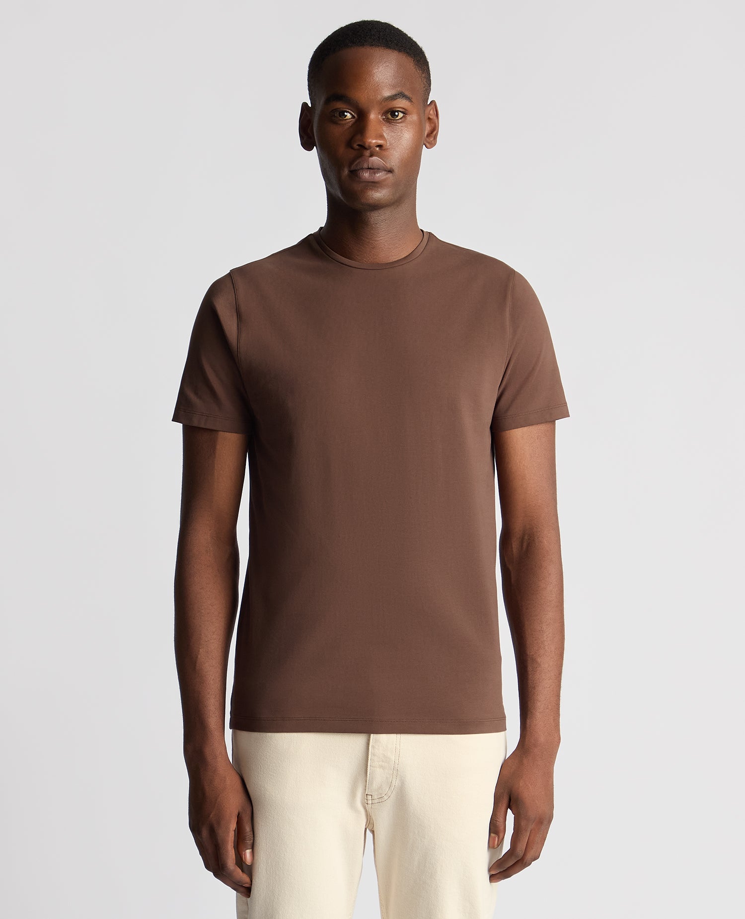 Man wearing a brown Tapered Fit Cotton-Stretch T-Shirt