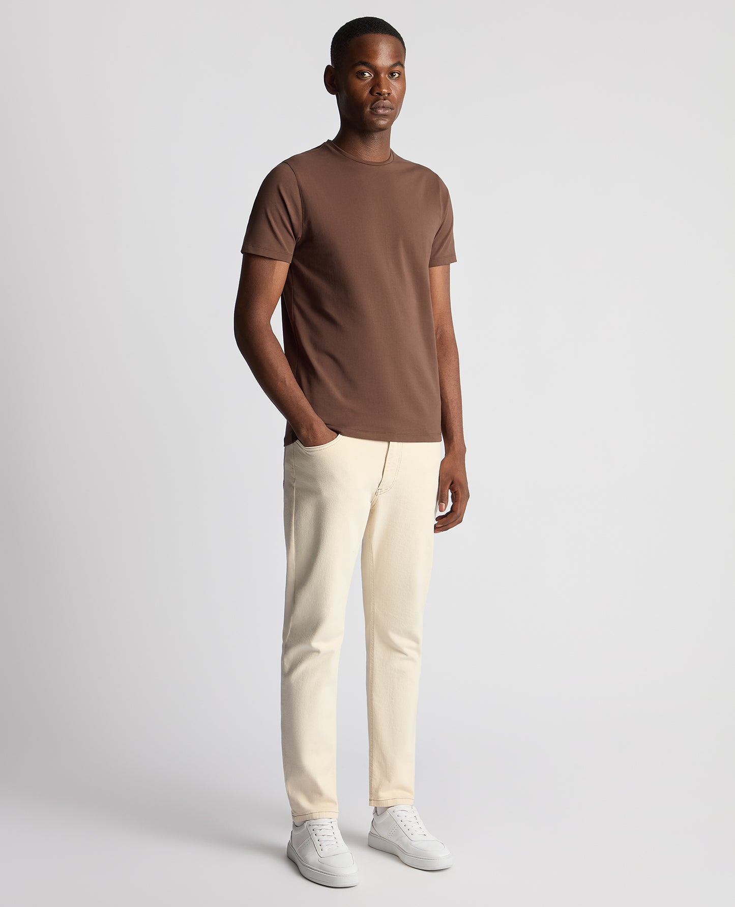 Man wearing a brown Tapered Fit Cotton-Stretch T-Shirt