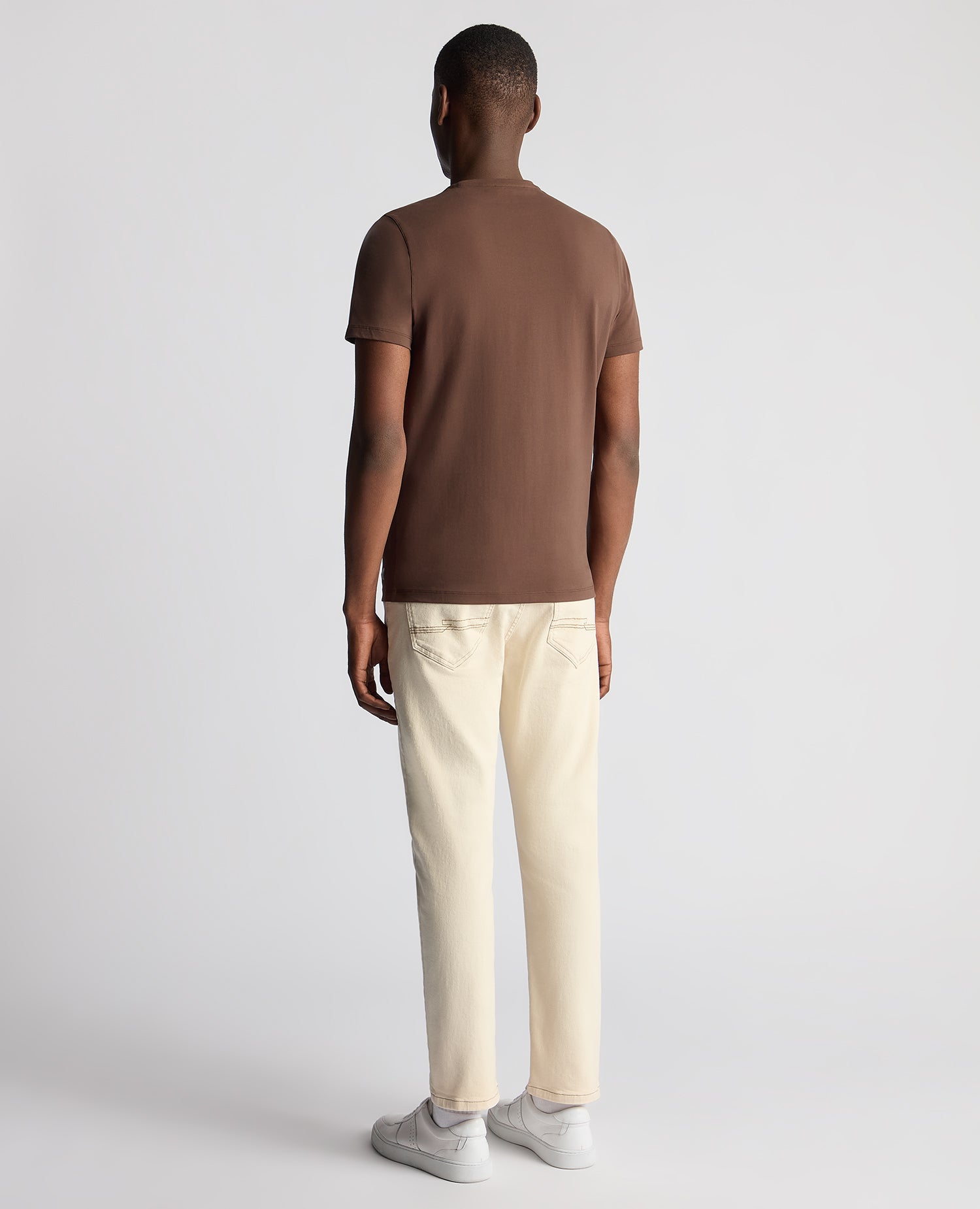 Man wearing a brown Tapered Fit Cotton-Stretch T-Shirt