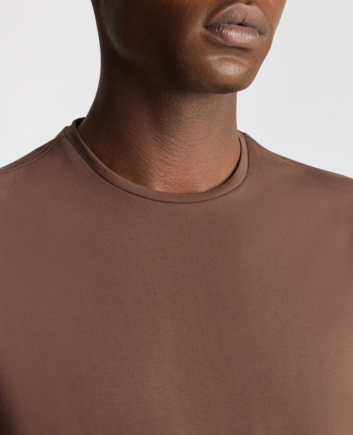 Man wearing a brown Tapered Fit Cotton-Stretch T-Shirt