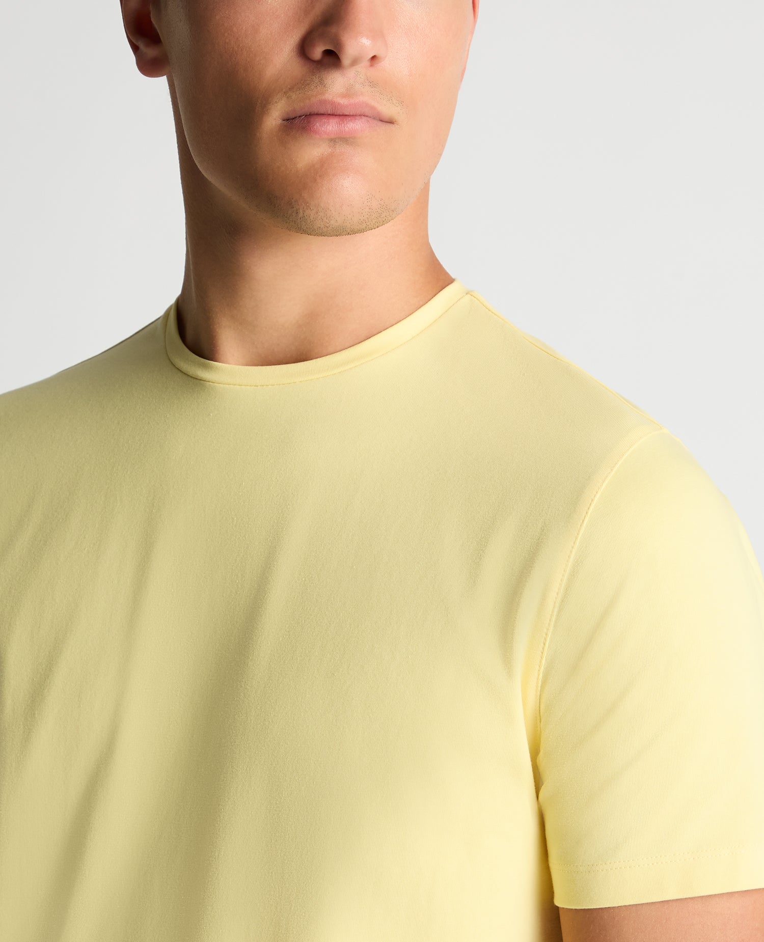 Man wearing a orange Tapered Fit Cotton-Stretch T-Shirt