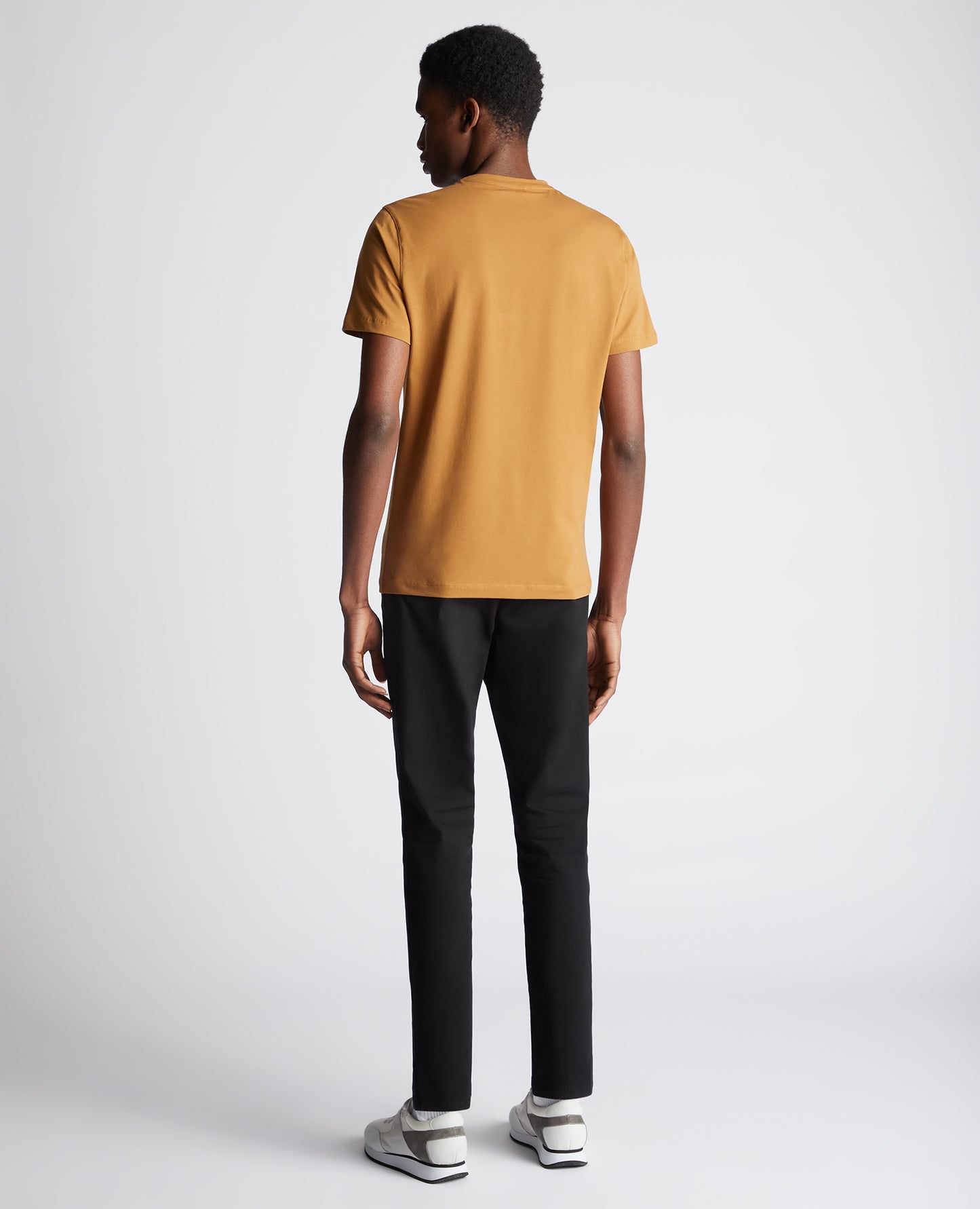 Man wearing a orange Tapered Fit Cotton-Stretch T-Shirt
