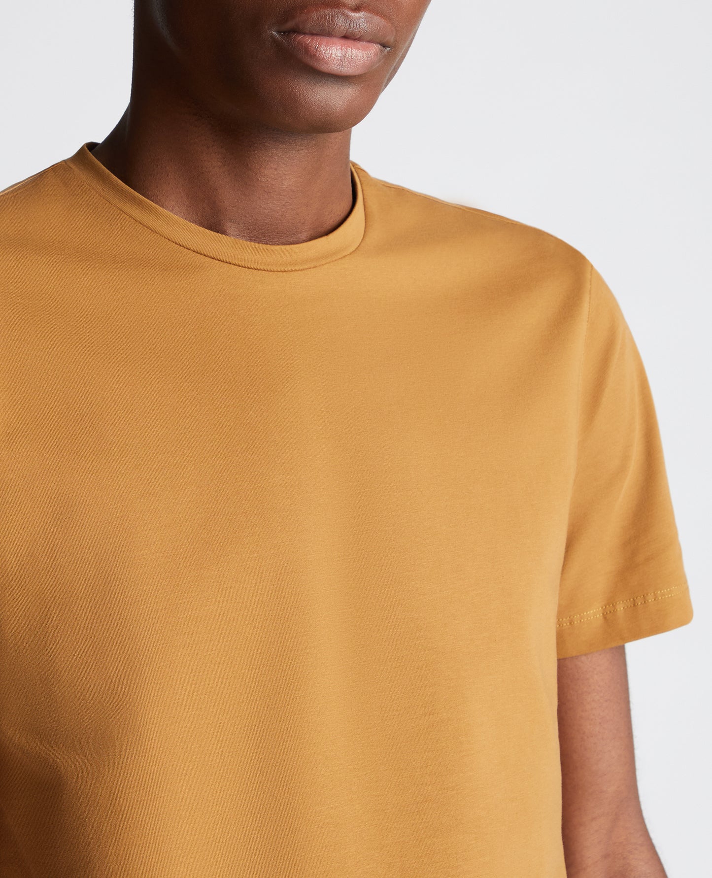 Man wearing a orange Tapered Fit Cotton-Stretch T-Shirt