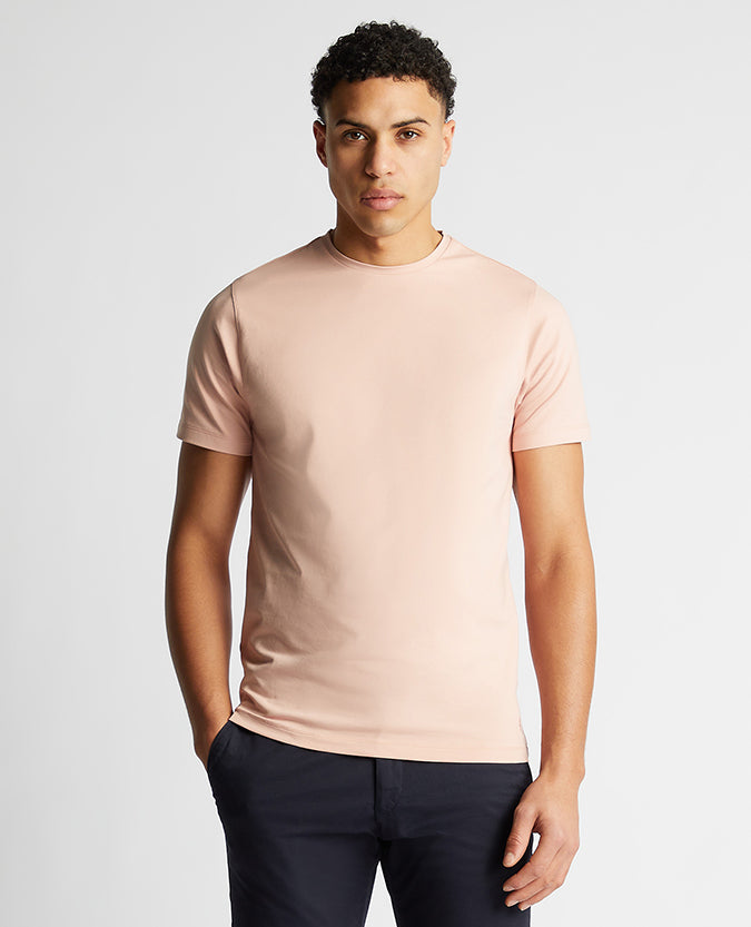 Man wearing a pink Tapered Fit Cotton-Stretch T-Shirt