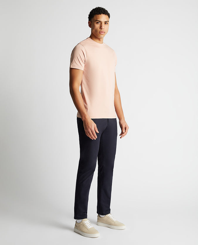 Man wearing a pink Tapered Fit Cotton-Stretch T-Shirt