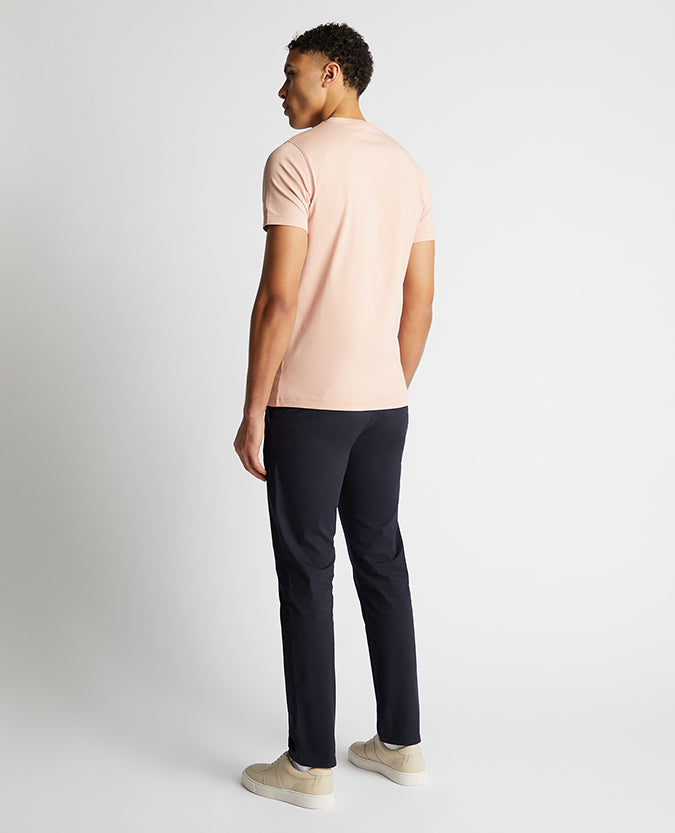 Man wearing a pink Tapered Fit Cotton-Stretch T-Shirt