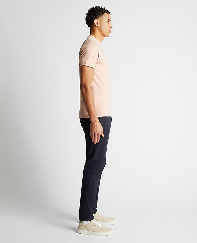 Man wearing a pink Tapered Fit Cotton-Stretch T-Shirt