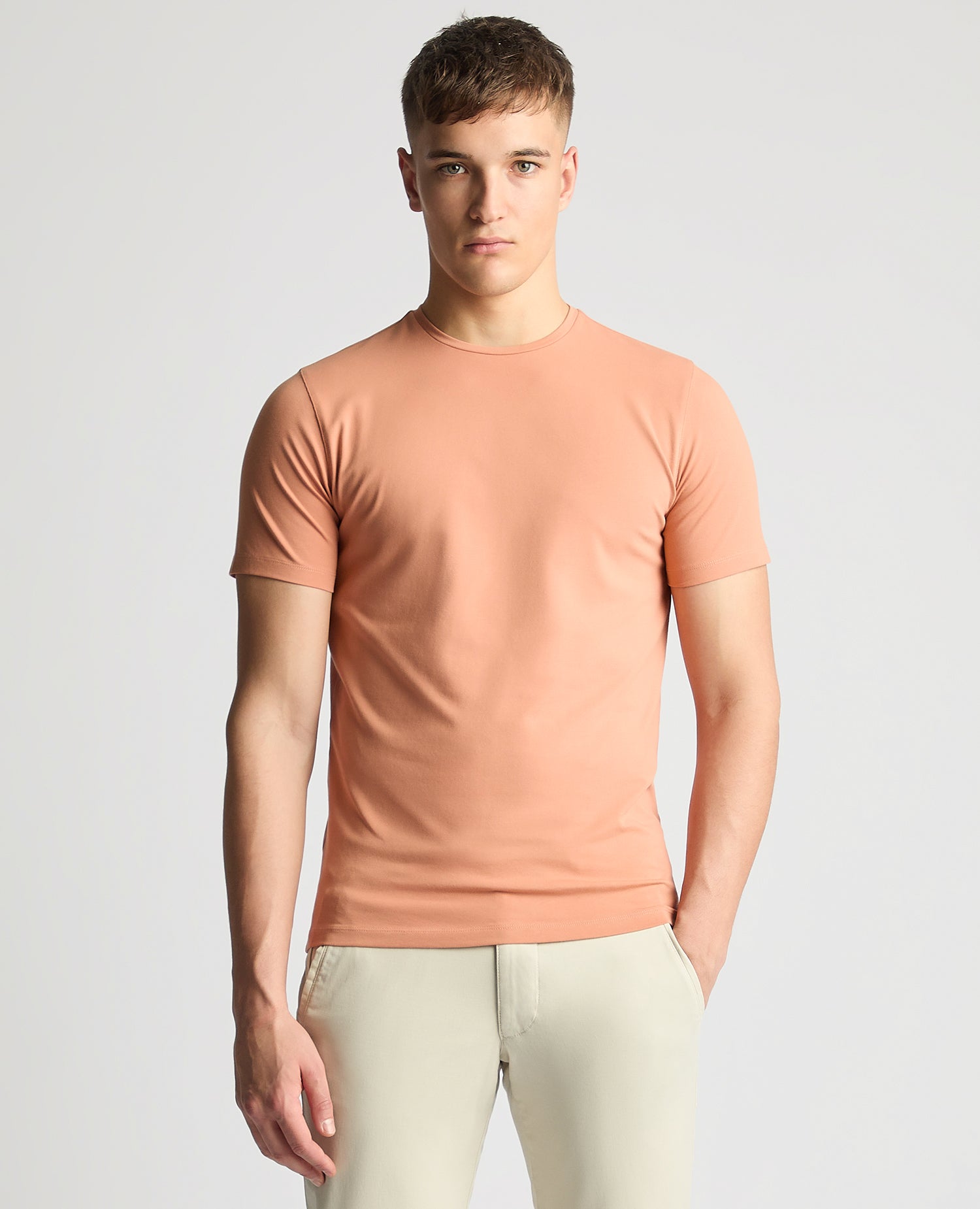 Man wearing a red Tapered Fit Cotton-Stretch T-Shirt