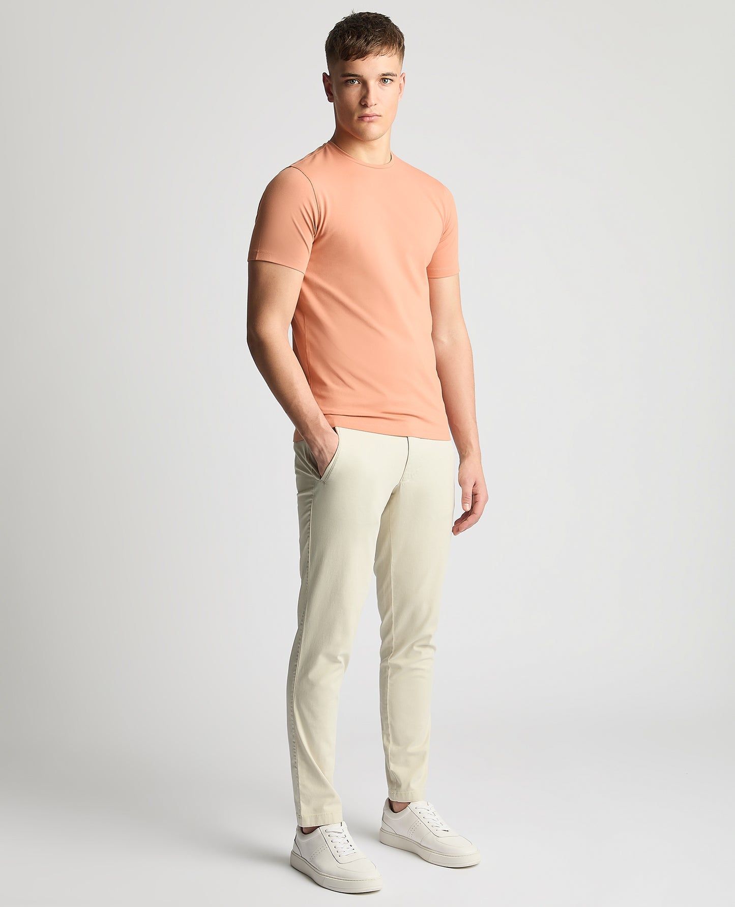 Man wearing a red Tapered Fit Cotton-Stretch T-Shirt