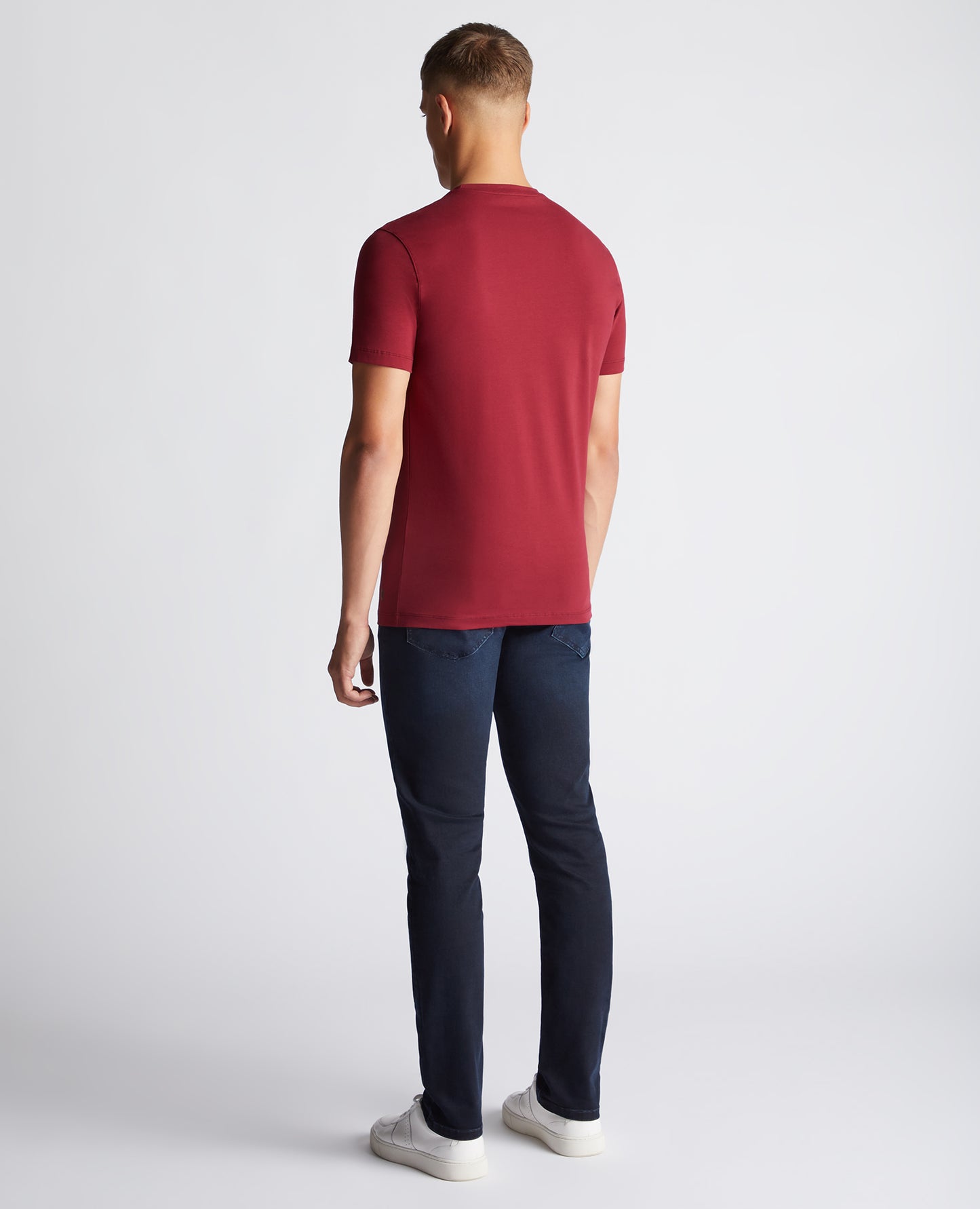 Man wearing a red Tapered Fit Cotton-Stretch T-Shirt