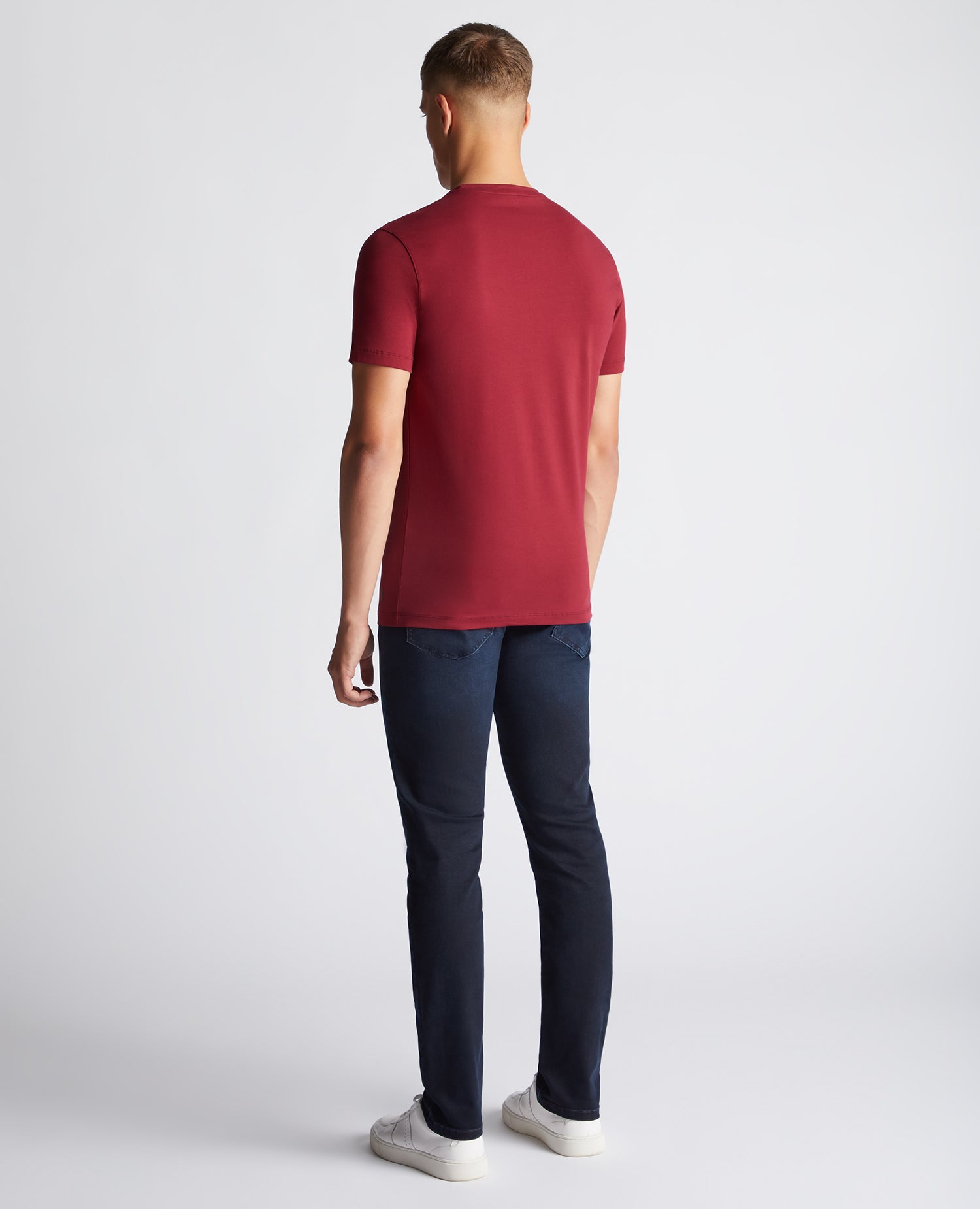 Man wearing a red Tapered Fit Cotton-Stretch T-Shirt