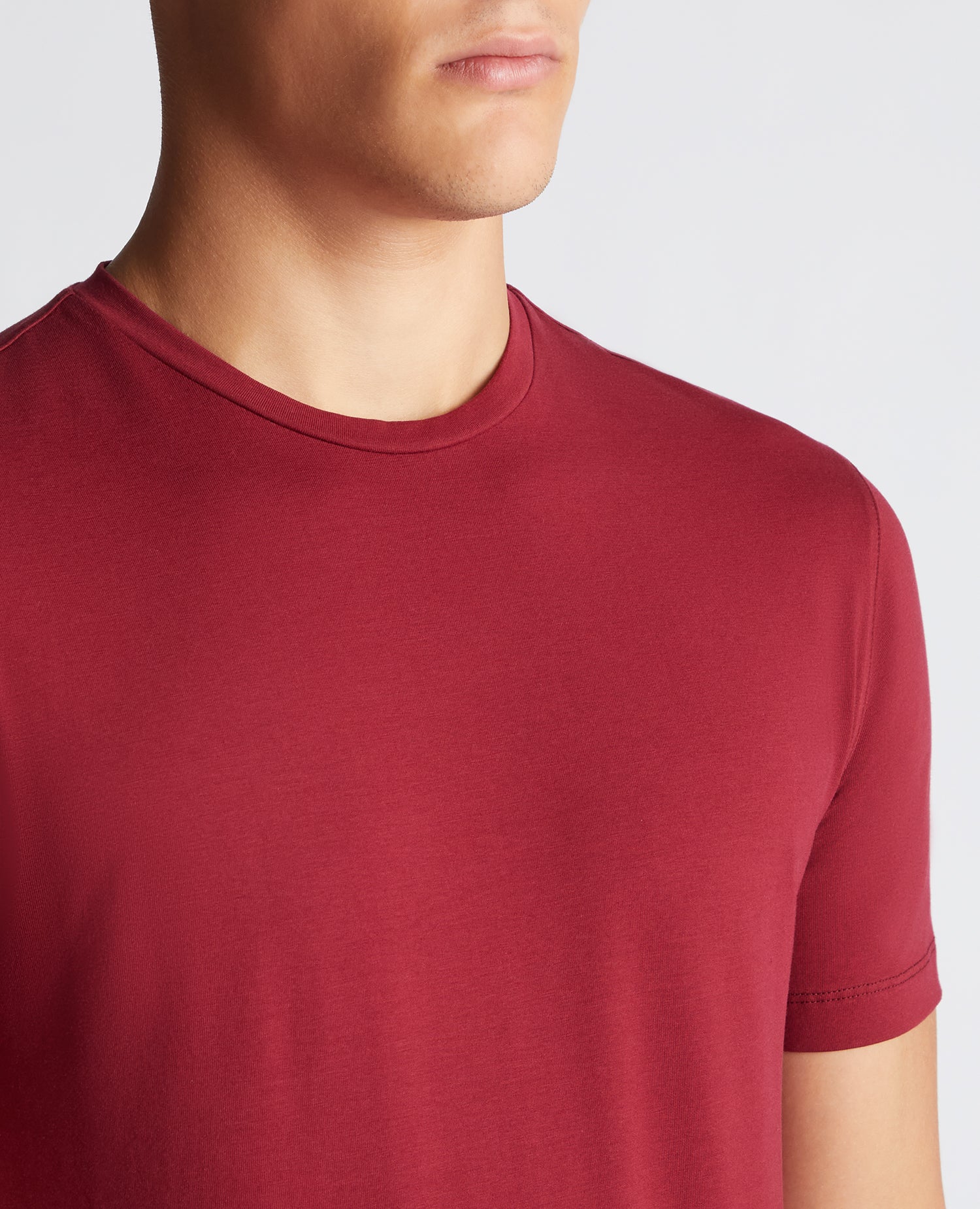Man wearing a red Tapered Fit Cotton-Stretch T-Shirt